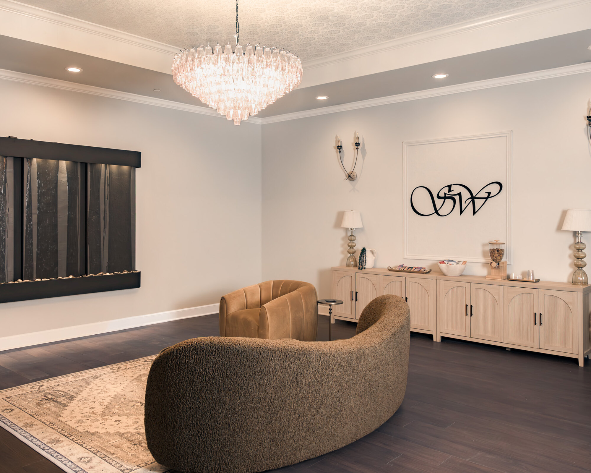 The Stillwater lobby — chandelier, walnut floor, cream walls